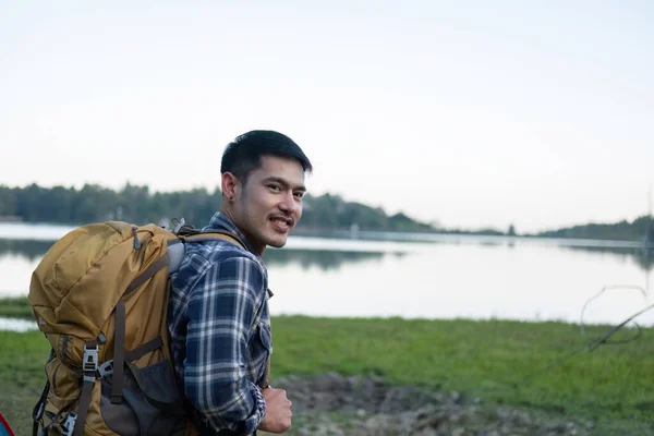 Asian tourist smiling happily Backpacker, hiking trips, outdoor activities on vacation..