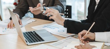 Asyalı iş adamları beyin fırtınası yaptılar ve iş planlarını tartıştılar. Konferans odasındaki şirketin mali veya istatistiksel rakamları.