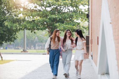 Group of Young Asian student walking and talking at university before class room. education, back to school concept.