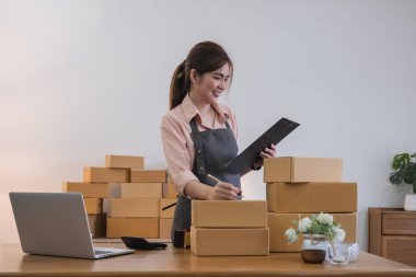 Başlangıçta küçük işletme girişimcisi KME, Asyalı kadın telefonla sipariş alıyor. Başarı genç Asyalı küçük işletme sahibi ev sahibi, çevrimiçi pazarlama teslimatı satıyor.