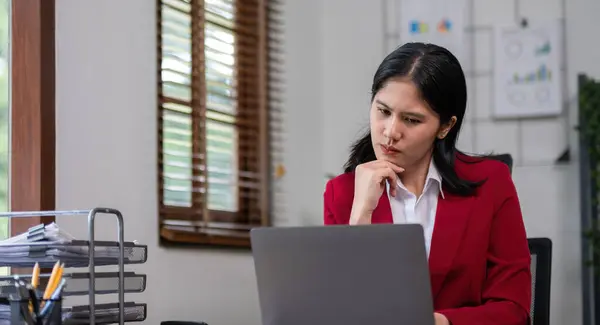 stock image Young businesswoman has problems with her work in the office Feeling stressed and unhappy, showing a serious expression.