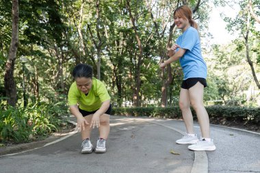 A young disabled woman stretches with her supportive friend in a park, highlighting friendship, fitness, and inclusivity. clipart