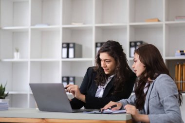 İş kadınları, modern bir ofis ortamında takım çalışması ve işbirliğini teşvik etmek amacıyla meslektaşlarıyla tartışma ve istişarede bulunurlar..