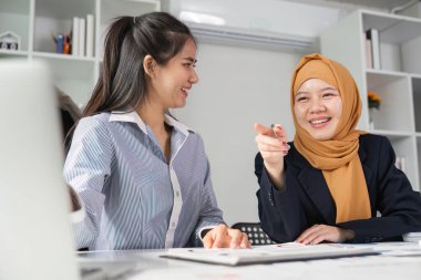 İki farklı finans uzmanı, çağdaş bir ofiste işbirlikçi bir atmosferi teşvik ederek, içgörü ve stratejileri paylaşıyor..