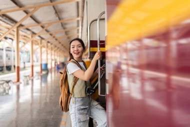Genç bir gezgin trene binmeye hazırlanırken fotoğraf ve maceraya olan hevesini göstermek için yeni hedefleri keşfetmeye hazır..