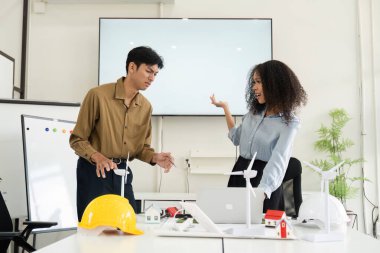 İki meslektaş, yaratıcı bir çalışma alanında sürdürülebilir projeleri için yenilenebilir enerji çözümleri üzerine canlı bir tartışmaya girişiyor..
