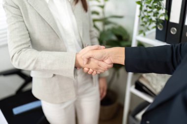 İki iş ortağının el sıkışması, finansal ilişkilerde güven ve ortaklığı temsil etmesi..