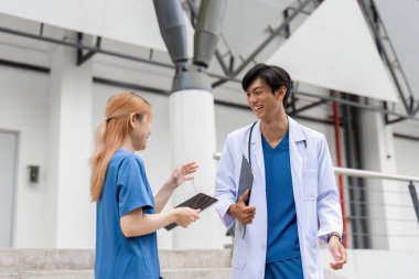 İki tıp öğrencisi kampüste canlı bir tartışma içinde. Takım çalışması ve sağlık alanında öğrenme..