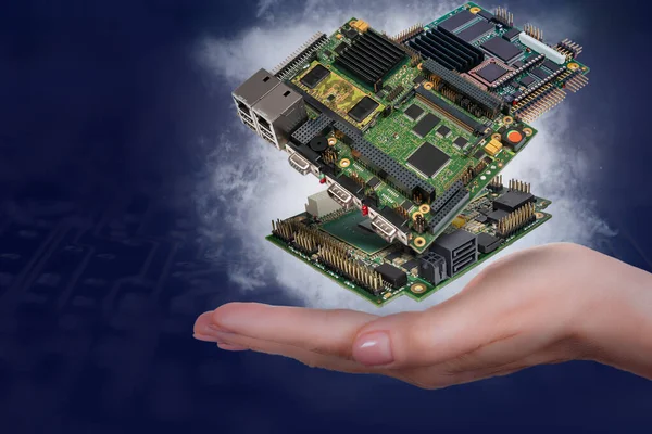levitating industrial embedded CPU boards above woman\'s hand on dark blue background