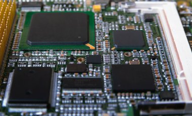 Modern teknoloji ve donanımı temsil eden mikroçipler, rezistanslar ve diğer bileşenlerin yer aldığı elektronik devre kartının ayrıntılı olarak kapatılması.