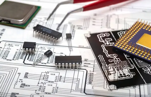 stock image Electronic components and tools on an engineering blueprint for circuit board design.