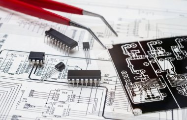 Electronic components and tools on an engineering blueprint for circuit board design. clipart