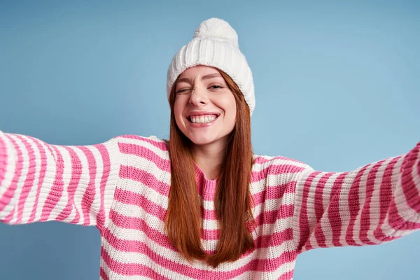 Playful Young Woman Winter Hat Making Selfie Winking Blue Background — Stock Photo, Image