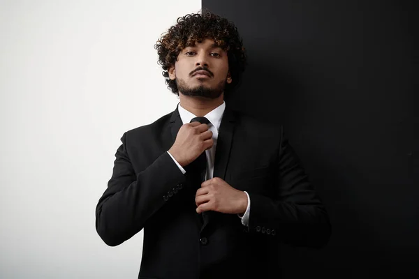 Confident Indian Businessman Adjusting His Necktie Black White Background — Stock Photo, Image
