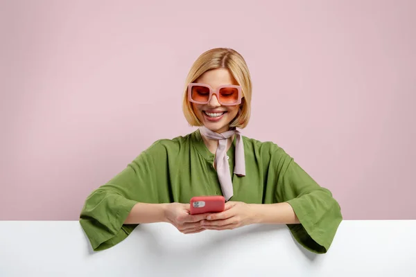 Модна Молода Жінка Спирається Місце Копіювання Використовує Телефон Рожевому Фоні — стокове фото