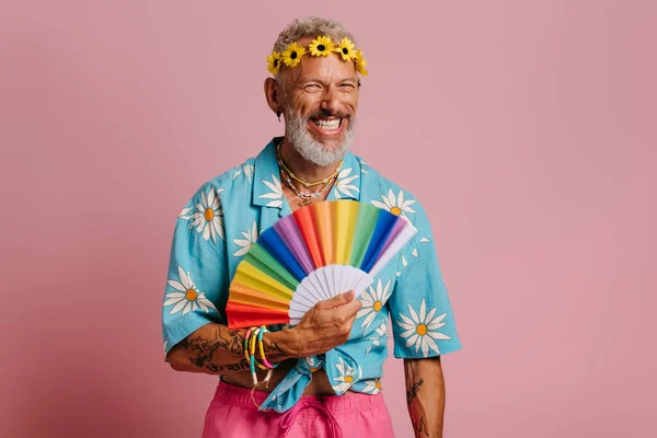Fashionable Mature Gay Man Floral Wreath Waving Hand Fan Smiling — Stock Photo, Image
