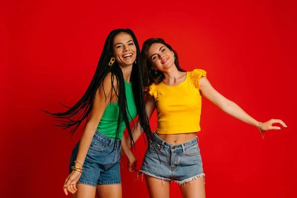 Two Happy Young Women Colorful Wear Dancing Red Background — Stock Photo, Image