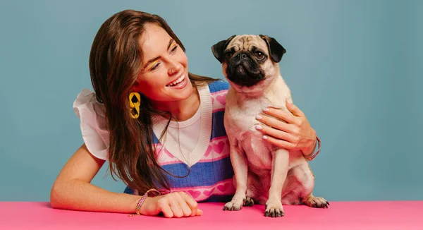Attractive Young Woman Hugging Cute Pug Dog Smiling While Sitting — Stock Photo, Image