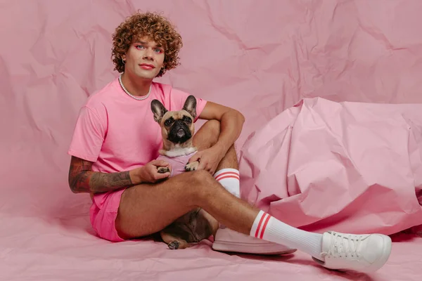 Stylish Young Gay Man Holding His Cute Dog While Sitting — Stock Photo, Image
