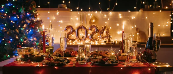 No people shot of dining table decorated with Christmas ornaments with cozy atmosphere of New Year Eve