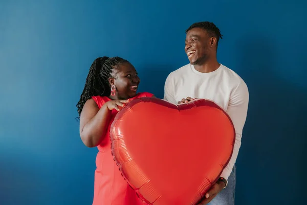 Щаслива Молода Африканська Пара Тримає Червону Кульку Формі Серця Стоячи — стокове фото