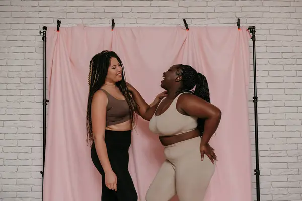 Duas Mulheres Africanas Felizes Size Sportswear Sorrindo Enquanto Unem Fundo — Fotografia de Stock