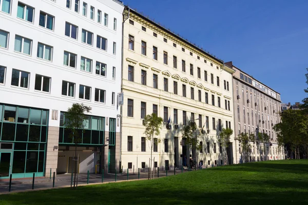 stock image Budapest, Hungary - February 23, 2015: Modern and historical aligned buildings with green space.