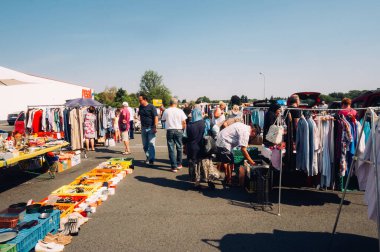 FRANKFURT, GERMANY - AUGUST 23, 2015 : People looking for clothes and other objects in a German haggle in Frankfurt, in a sunny day.
