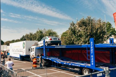 FRANKFURT, GERMANY - AUGUST 24, 2015 : Pose of people walking near a huge trail stopped in a parking place in Frankfurt.