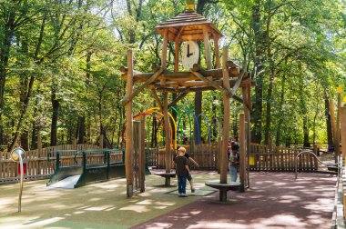 FRANKFURT, GERMANY -AUGUST 27, 2015 : Children playing  in a wooden playground and having fun in park.