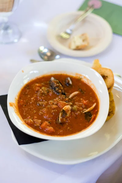 Seafood soup of clams, fish, and mussels at a wedding reception dinner.