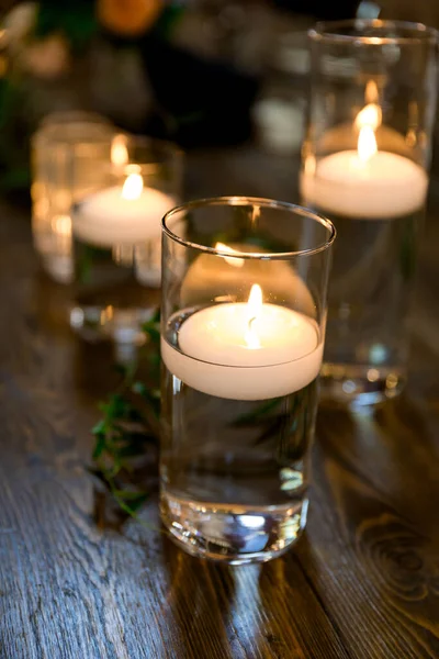 Wedding reception candles in jars of water for an indoor celebration in Oregon.
