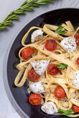 pasta with sauce and cheese on a light background