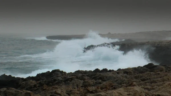 rocky cliff in the sea, the waves crashing into the sea, Protaras, Cyprus.