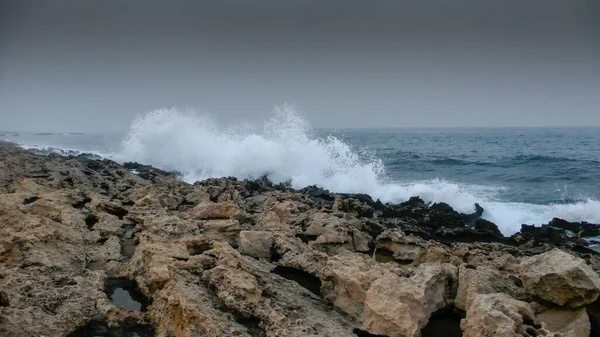 rocky cliff in the sea, the waves crashing into the sea, Protaras, Cyprus.