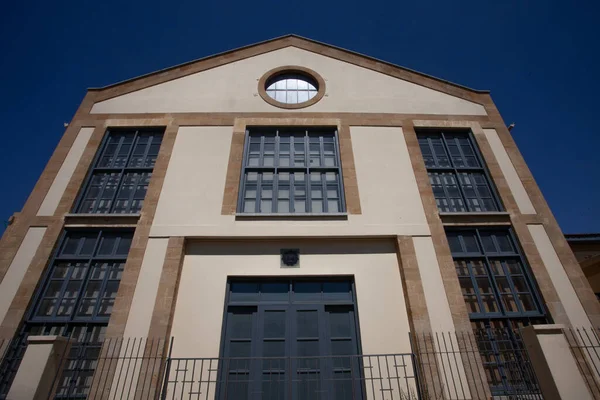 building facade with windows, architecture exterior, blue sky, day time 