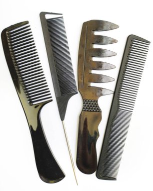 Stylish black combs of various designs, neatly arranged on a white background.  Perfect for hair styling concepts, beauty blogs, or barber shop imagery.  Implies order, grooming, and selfcare. clipart