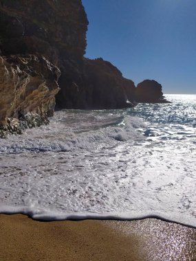 Deniz kenarı sahnesi. Dalgalar kıyıya vuruyor, uçurumlarla çelişiyor. Huzurlu manzara, seyahat, doğa ya da kıyı teması için ideal. Huzur ve keşfi çağrıştırır.