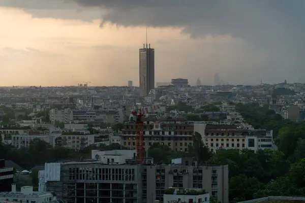 stock image Paris, France - May 7, 2023: Hyatt Regency tower with Arc de Triompthe with storm arriving soon