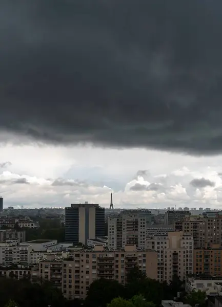 stock image Distant view of Eiffel Tower under heavy dark clouds in summer