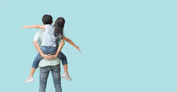 Happy asian family of father and daughter hug spread out your arms, Back view isolated on blue background with Clipping paths for design work empty free space