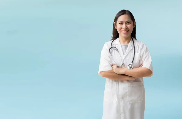 Smiling Asian Female Doctor Coat Posing Arms Crossed Isolated Blue —  Fotos de Stock