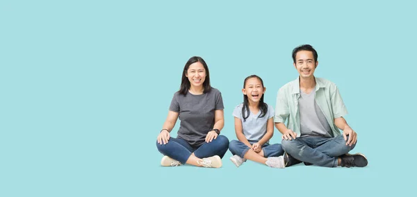 Happy smiling young asian family sitting on floor have a fun time together, Full body isolated on pastel plain light blue background