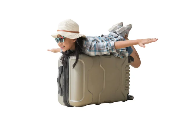 快乐的笑着的亚洲小女孩坐在手提箱探险旅行梦想的概念 全身上下被白色背景隔离 为设计工作开辟道路 图库照片