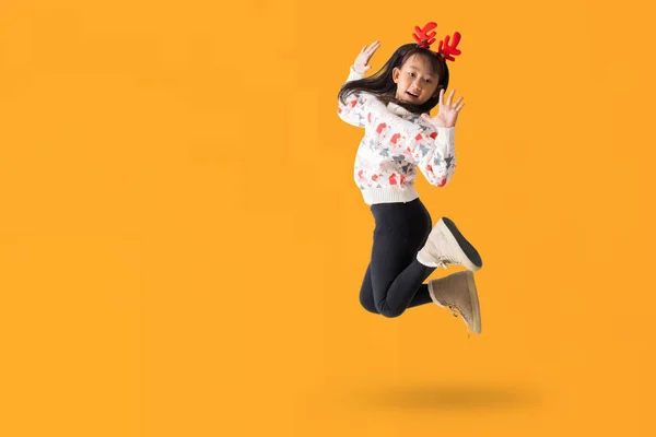 トナカイの角が付いているクリスマスのセーターを身に着けている陽気な若いアジアの少女 白い背景で隔離された完全なボディの肖像画を跳躍する幸せな笑顔のダンス 設計仕事のためのクリッピングの道 — ストック写真