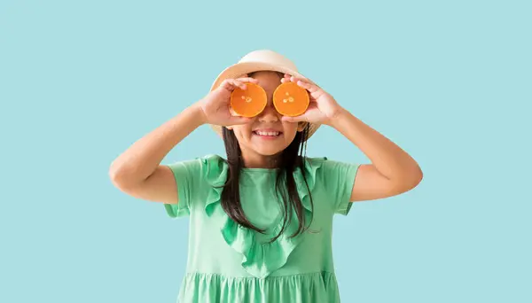 Happy Asian Little Girl Posing Wear Hat Sunglasses Holding Orange Stock Image