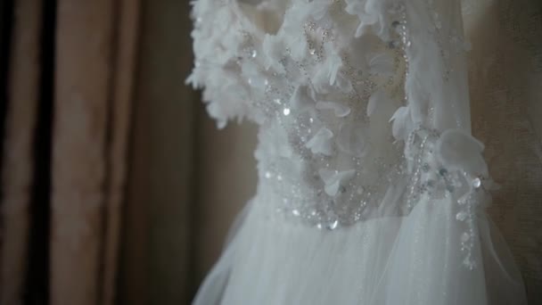 stock video wedding dress hanging on a hanger on a chandelier