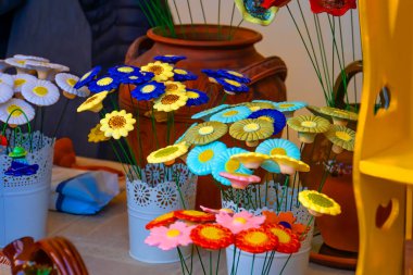 handmade clay vases with flowers on the table