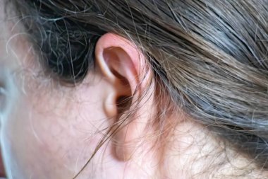 Man with on ear listening for quiet sound or paying attention