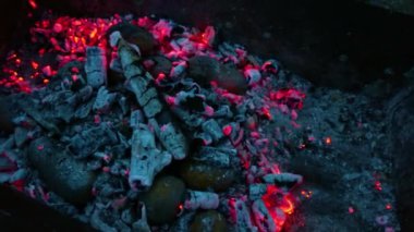 Kuru ağaç dalları parlak bir alevle yanar. Ateş, şenlik ateşinde odun yığınını yakıyor. Kütükler artık kömüre dönüştü..